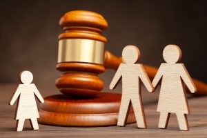 Deprivation of parental rights. The law protects children from p Deprivation of parental rights. The law protects children from parental violence. Mother and father apart from the child and judge's hammer.